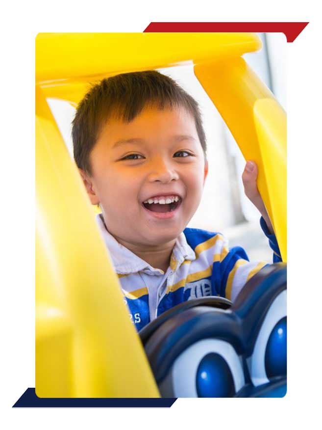 Preschool boy in play car